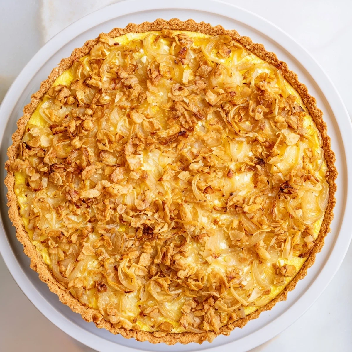 Golden, bubbly Decadent Caramelized Onion and Goat Cheese Tart, perfect for a cozy brunch.