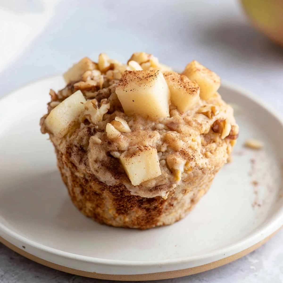 A close-up of golden brown Seasonal Spiced Pear and Walnut Muffins fresh from the oven, inviting aromas.