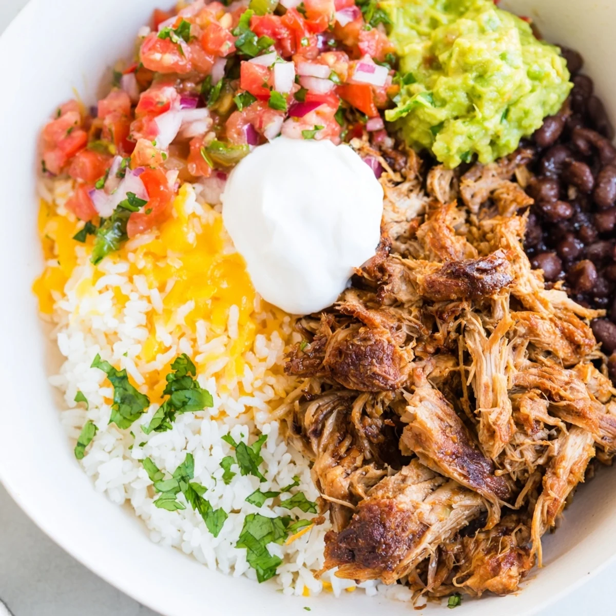 Chipotle Burrito Bowl Copycat: A vibrant arrangement of ingredients with creamy queso and fresh salsa.