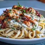 Viral Marry Me chicken pasta studded with sun-dried tomatoes and fresh basil.