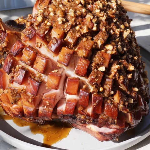 Golden, glistening Slow-Cooked Honey Glazed Ham, a holiday centerpiece ready to be sliced and shared.