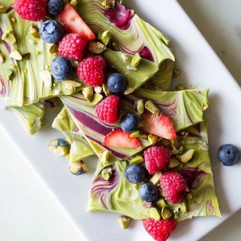 Creamy, swirled Frozen Yogurt Bark, a refreshing dessert featuring matcha and fresh berries.