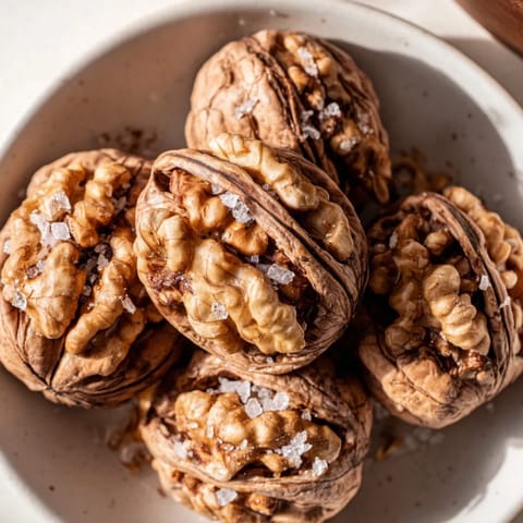 Close-up of freshly baked sweet and salty honey toasted cashews revealing a perfect coating and texture.