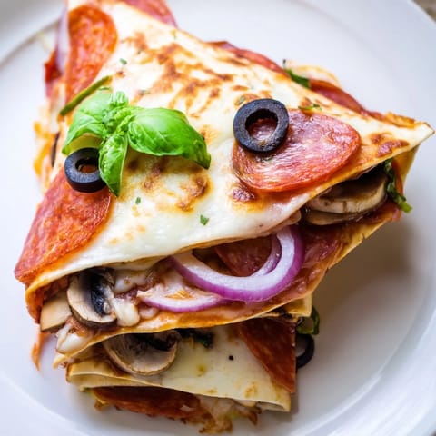 This delicious Cheesy Tortilla Pizza Wrap features layers of melted cheese and pizza toppings, ready to enjoy.