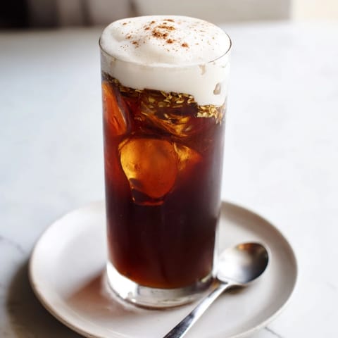 See the beautiful layers: chilled Homemade Iced Chai, topped with billowy, sweet cold foam dusted with cinnamon.