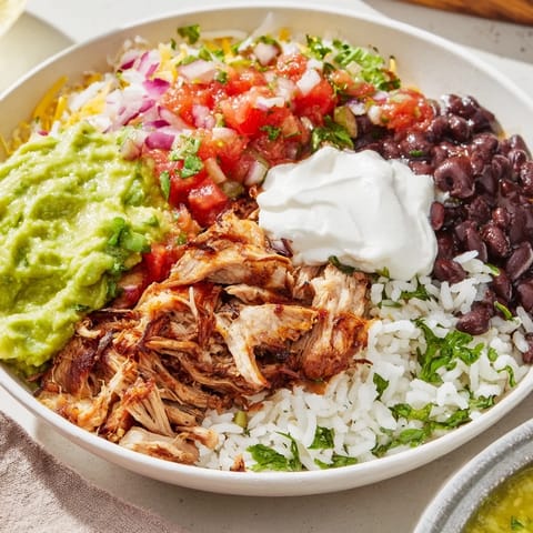 Flavorful Chipotle Burrito Bowl Copycat, piled high with tender carnitas, ready to enjoy with every bite.