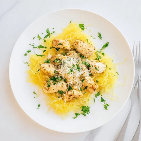 Golden roasted spaghetti squash strands topped with tender lemon garlic chicken, finished with fresh parsley and grated Parmesan cheese.