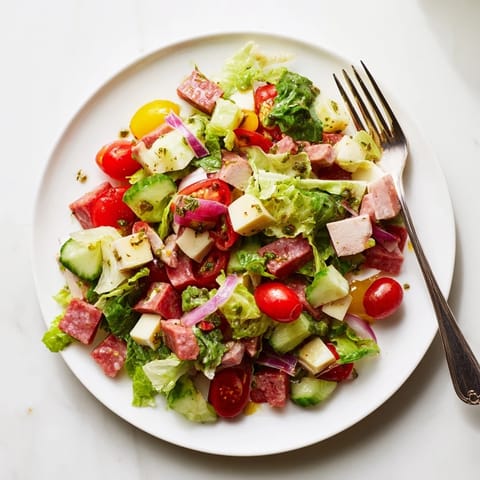 Fresh Italian Deli Chopped Chicken Salad with tender chicken, salami, provolone, and crisp veggies on a plate.
