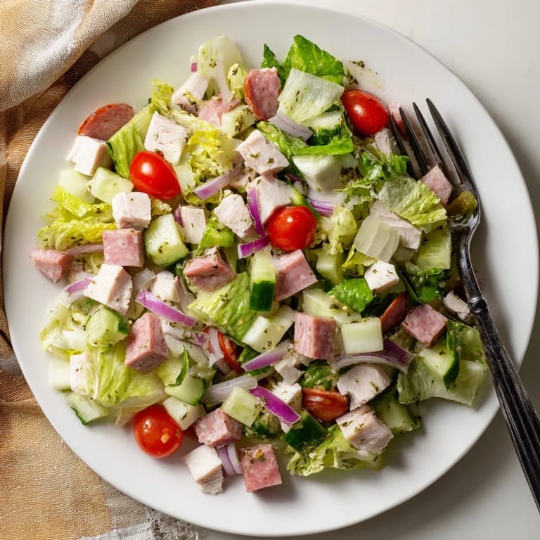 A vibrant bowl of Italian Deli Chopped Chicken Salad with pepperoncini and a tangy herb dressing.