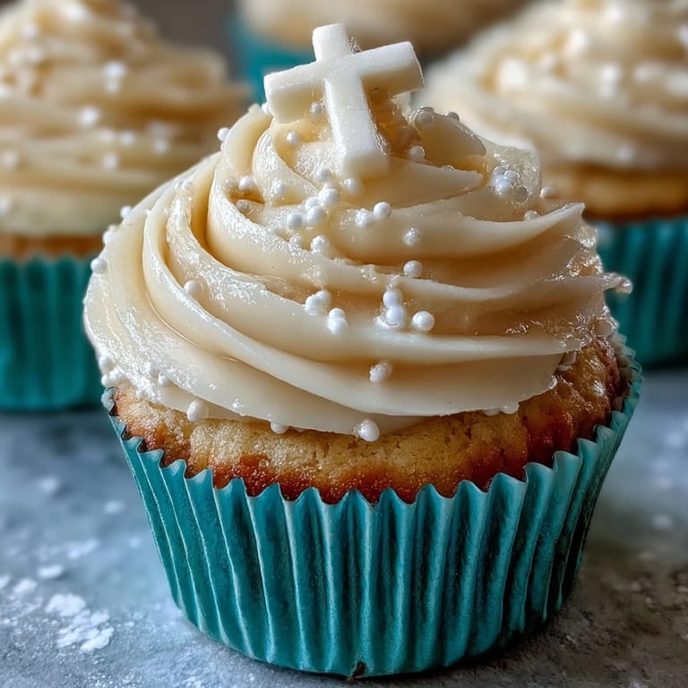 Moist vanilla communion cupcakes, finished with luscious buttercream and a sweet, edible white cross.