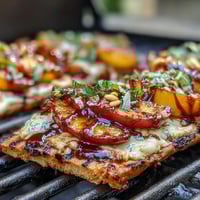 Smoky BBQ Peach and Brie Flatbread on the Grill, topped with grilled peaches and melted Brie