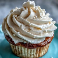 Sweet communion cupcakes, adorned with a tender vanilla cake and delicate white fondant cross topping.