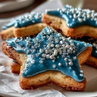 Gemini Zodiac cookies with star royal icing, glistening under dreamy celestial frosting.